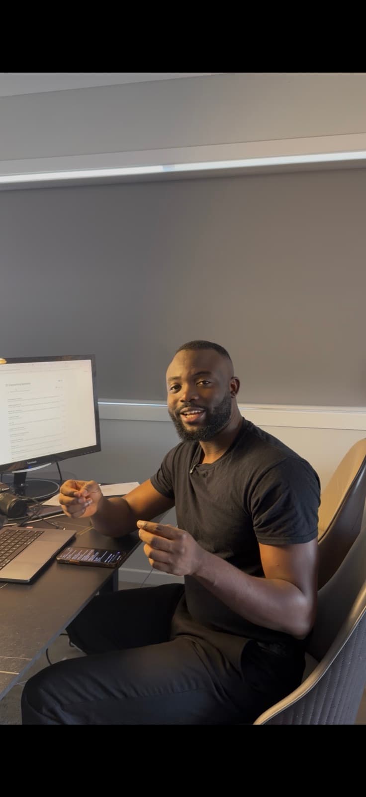 Noah Oloja at his desk